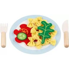 Tallrik med pasta och grönskar i trä och tyg