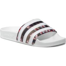 Damen - Textil Slides Adidas HER Studio London Adilette - Metallic Gold/Cloud White/Core Black