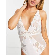 A Bodysuits Dorina Lilias poly blend lace plunge front bodysuit with cross back detail in