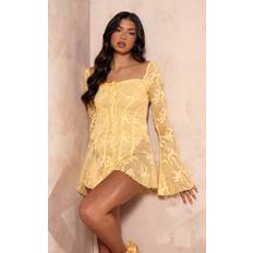 Yellow Jumpsuits & Overalls PrettyLittleThing Lemon Lace Binding Detail Flare Sleeve Playsuit, Lemon