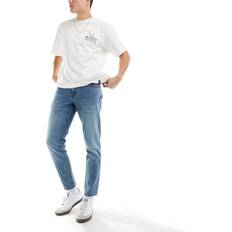 L34 - Unisex Jeans ASOS DESIGN Tapered jeans med stretch mellemblå vask