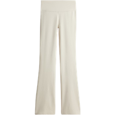 Beige - Fitness & Gym Tights H&M Flared sports leggings with DryMove - Light Beige