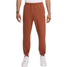 Nike Orange Byxor Nike Court Dri-fit Heritage Fleece Träningsbyxa Herrar - Rost
