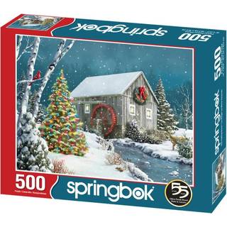 Springbok The Falling Snow 500 Piece Jigsaw -puslespil for voksne har en feriehytte, der gl?dende i sneen med et dekoreret juletr? ved siden af ?