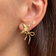 Stine A Dangling Flow Bow Earring - Gold/Transparent