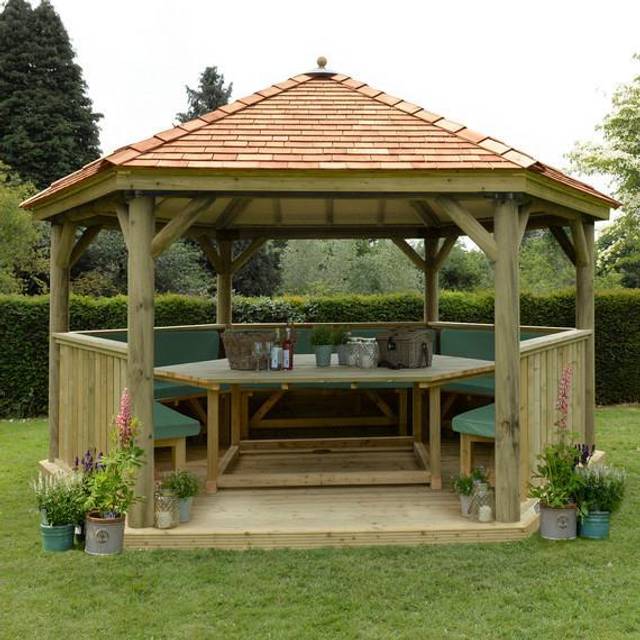 Hexagonal 4.7m Cedar Roof Gazebo with Table, Benches & Green Cushions (Installed) - Treated Timber - Forest Garden