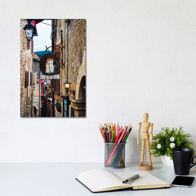 Medieval Street With Signs and Lamps, Sermoneta, Italy by George Oze - Wrapped Canvas Photograph (20.32 cm H x 30.48 cm W)