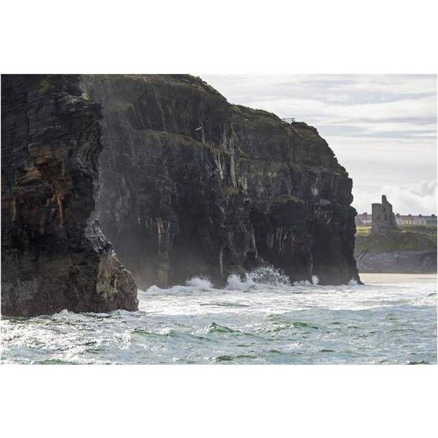 Dark Straight Cliffs with Waves Crashing Into The Rock with Ruined Castle Turret in Background - Ballybunion County Kerr Poster Print - 19 x 12 in.