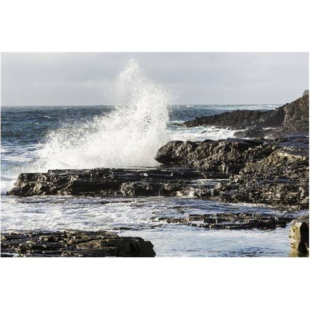 Wave Crashing Into Rocky Coast with Cloudy Sky - Kilkee County Clare Ireland Poster Print - 19 x 12 in.