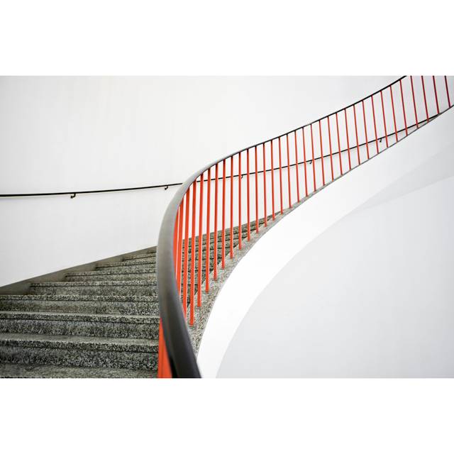 Alcazar Curved Stairs with Red Banister by Alan Graf - Wrapped Canvas Photograph (81cm H x 122cm W x 3.8cm D)