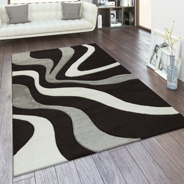 Designer carpet with contour cut and a wave pattern in black grey and white