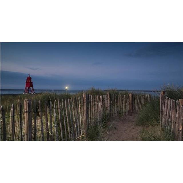 A Sand Pathway Lined with A Wooden Fence Leading To The Beach with The Herd Groyne Lighthouse on The Waters Edge Poster Print - 42 x 22 in. - Large