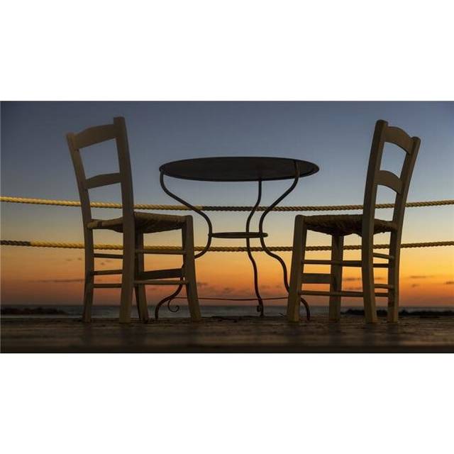 A Table & Chairs on A Patio with A View of A Colourful Sunset - Paphos Cyprus Poster Print - 40 x 22 in. - Large
