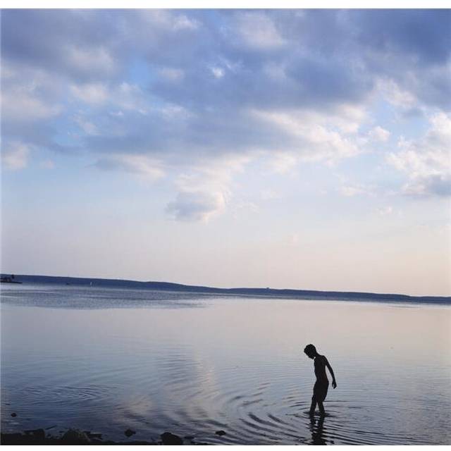 Boy In Silhouette Wading In Ocean Poster Print, 24 x 24 - Large