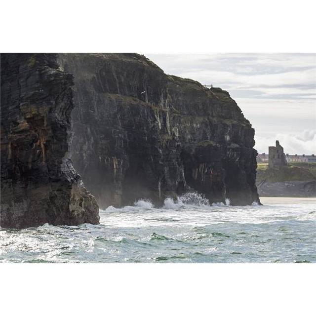 Dark Straight Cliffs with Waves Crashing Into The Rock with Ruined Castle Turret in Background Poster Print - 38 x 24 in. - Large