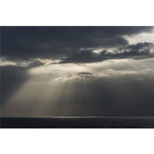 Sunlight Breaks Through The Clouds Over The Ocean On The Oregon Coast Cannon Poster Print by Robert L.Potts, 36 x 24 - Large