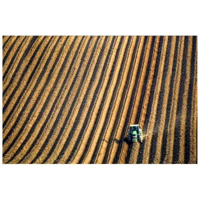 Tractor Plowing A Field Poster Print by John Short, 34 x 22 - Large