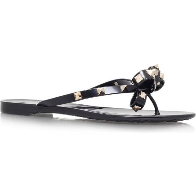 Rockstud Flip Flops - BLACK - The Rockstud reigns supreme as Valentino Garavani's detail of choice with these dainty PVC flip flops. Their glossy black design is complemented by the gold-toned platinum, while a knotted bow on the toe post lends further femininity.