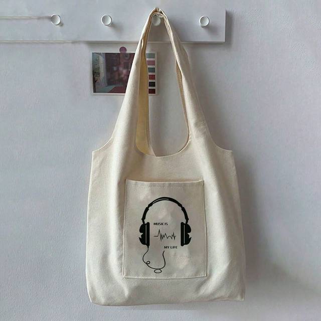 SHEIN One Stylish Beige Women Canvas Bag Marked With Musicismylife And Black Earphone Pattern, Featuring A Simple Design, Vest Straps, Pocket And Tote Patte