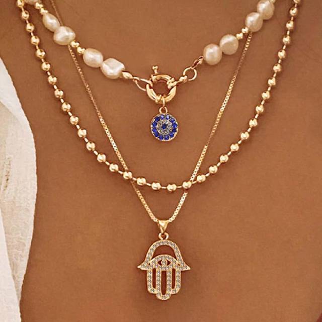 SHEIN 1pc Exaggerated Zinc Alloy Rhinestone & Pearl Eye Palm Pendant Multilayer Necklace