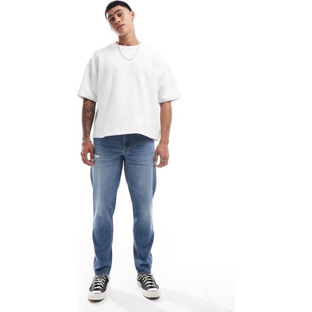 ASOS DESIGN – Mellanblå, avsmalnande jeans med slitna detaljer