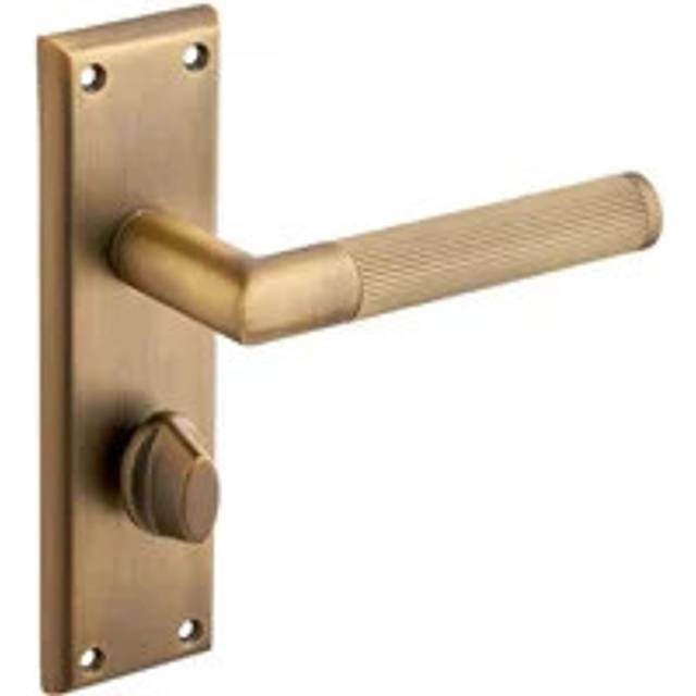 Newington Fluted Bathroom Thumb Lock Door Handle On Backplate - Antique Brass - Designer Levers