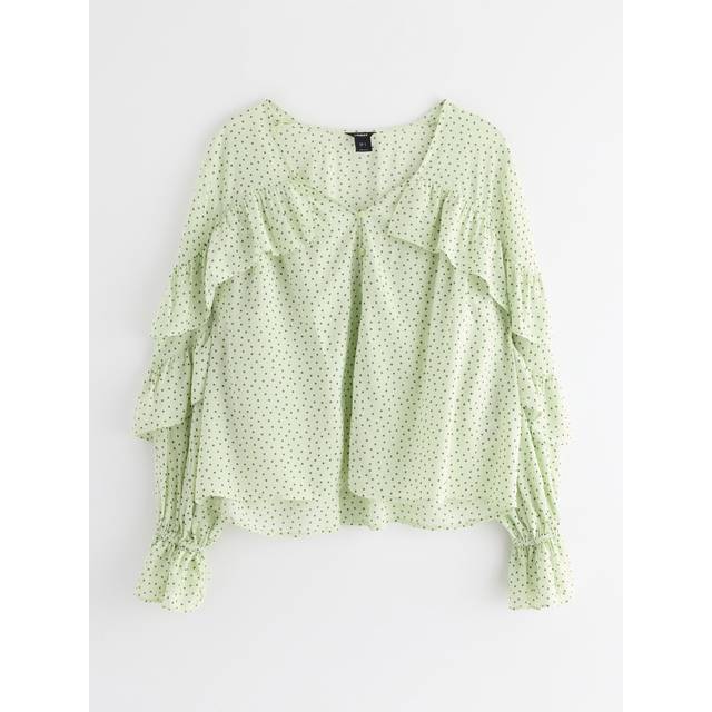 Blus med volang