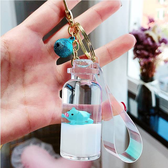(BlueMatte Blue) Milk Floating Pig Keychain With Purple Bell And Acrylic Liquid Sand Design