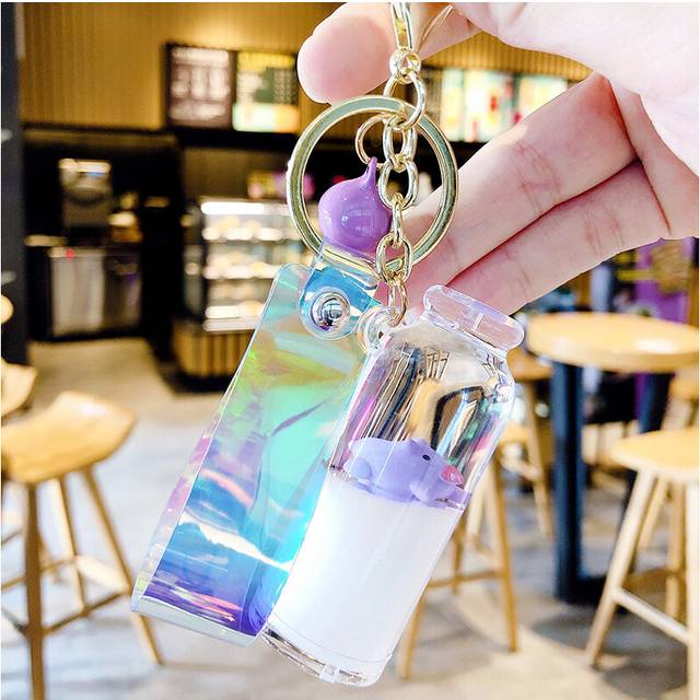 (PurplePurple) Floating Milk Pig Keychain With Purple Bell And Acrylic Liquid Sand Design