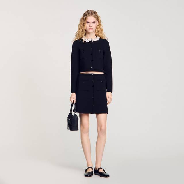 High-Rise Knitted Mini Skirt - BLACK - Evelyne and Didier Chetrite founded Sandro in 1984, setting up shop in Paris. The brand's design aesthetic is inspired by Evelyne's childhood in Morocco and classic Parisian chic style, resulting in collections filled with flowing silhouettes, feminine details and vibrant hues and prints. Offering an array of wardrobe staples, occasionwear and accessories, there is something for everyone.