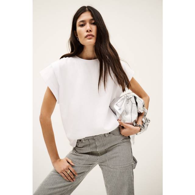 Pio Shoulder Pad T-Shirt - WHITE - Add a touch of Parisian flair to your weekly edit with ba&sh, a brand built on the foundation of Barbara Boccara and Sharon Krief’s childhood friendship and passion for fashion. With a focus on providing staples for your everyday wardrobe that can transcend seasons, the label offers everything from basics to outerwear and occasionwear, all finished with intricate details and brimming with a lively, joyful elegance.