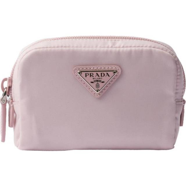 Re-Nylon Necessaire Pouch - Pink - In 1913, Mario Prada opened the very first Prada store in the luxurious Galleria Vittorio Emanuele II in Milan, selling bags, trunks and travel accessories. In the '70s, the brand expanded its range to include footwear, belts and more, all highlighting a design aesthetic that transcends trends. A sleek, understated triangle logo is the seal of authenticity and proudly adorns many of the fashion houses pieces.