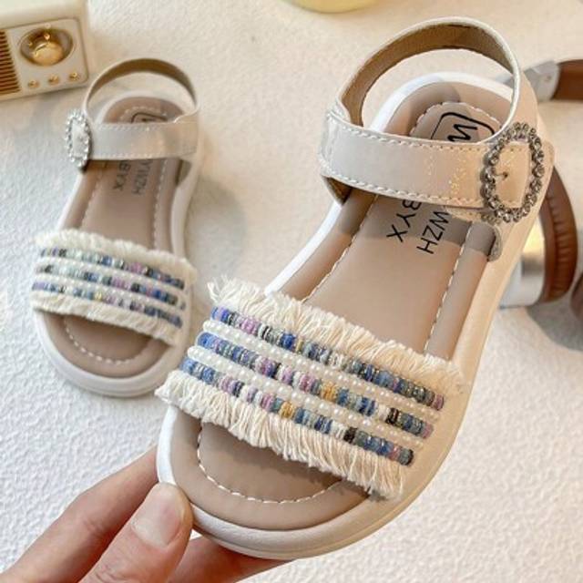 SHEIN A Pair Of Best-Selling Children&#39;s Sandals. The Main Body Of The Upper Is Beige, Decorated With Colorful Rhinestones, Pearls And Fringe Elements, Ankle