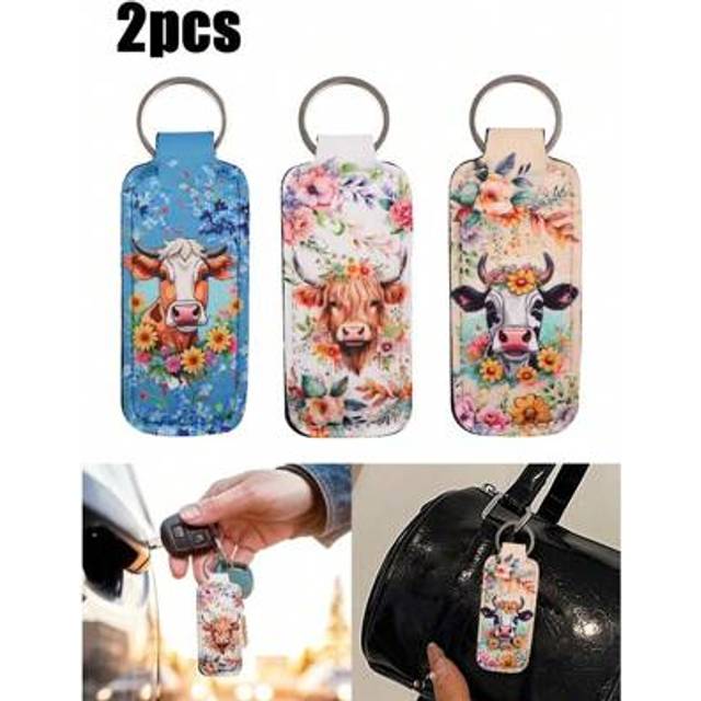 SHEIN 2pcs Charming Highland Cow Bag Pendant,Cow Sunflower Flower Cattle Clip On Lipstick Holder Keychain,Print Cartoon Keyring Lip Balm Key Chain Bag Charm