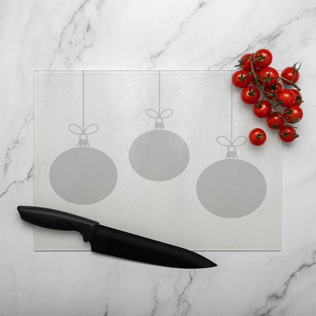 three hanging christmas baubles dining glass chopping board